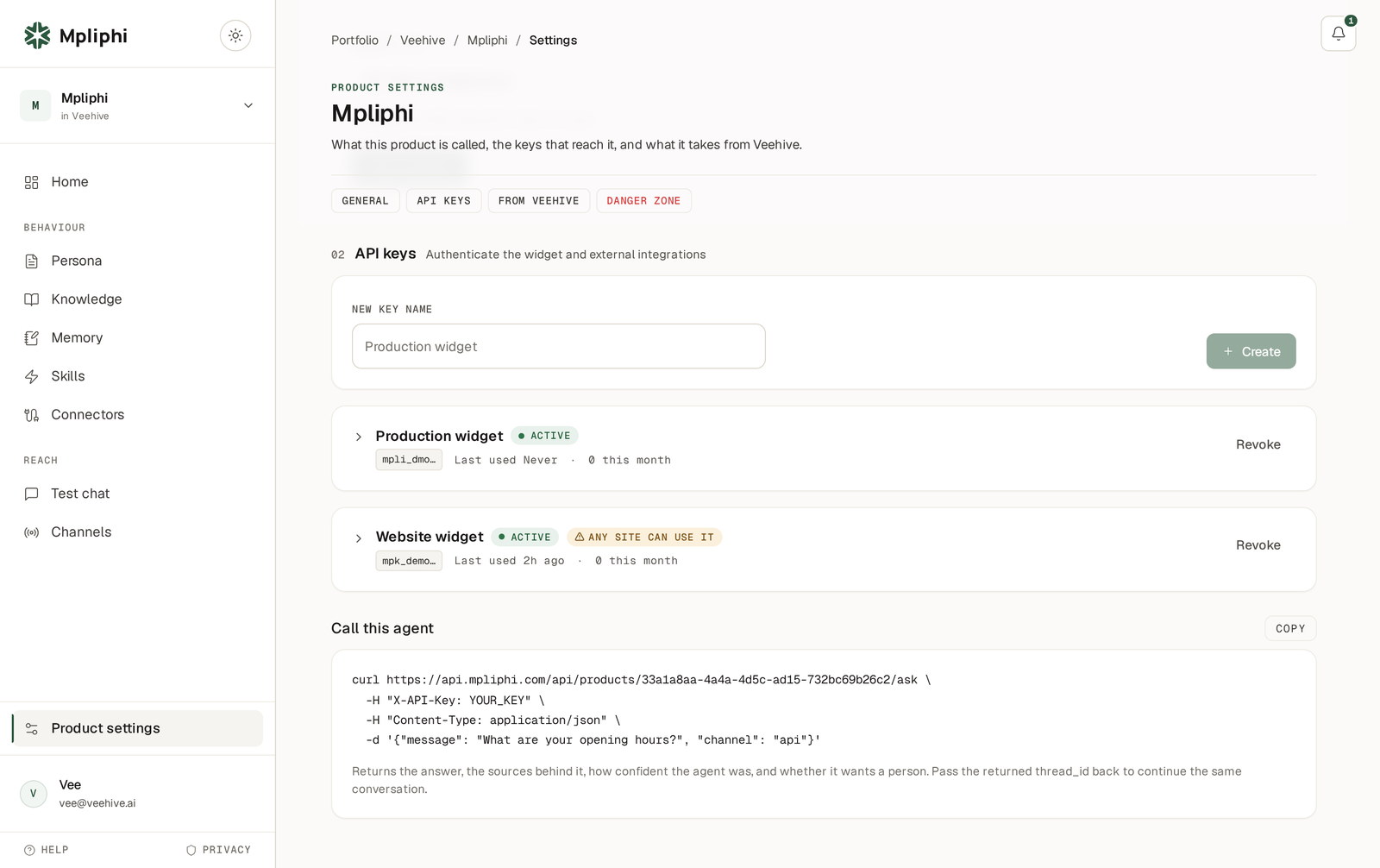 The API keys screen for Mpliphi, showing two active keys with their usage against monthly caps, a revoke control on each, and a sample curl call returning the answer with its sources and confidence.